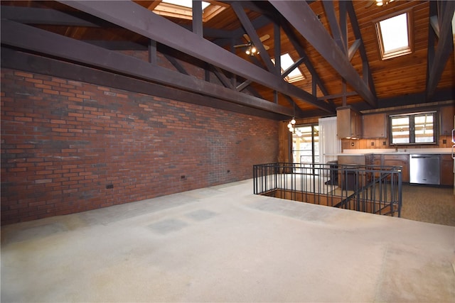 unfurnished living room featuring beam ceiling, high vaulted ceiling, brick wall, and carpet