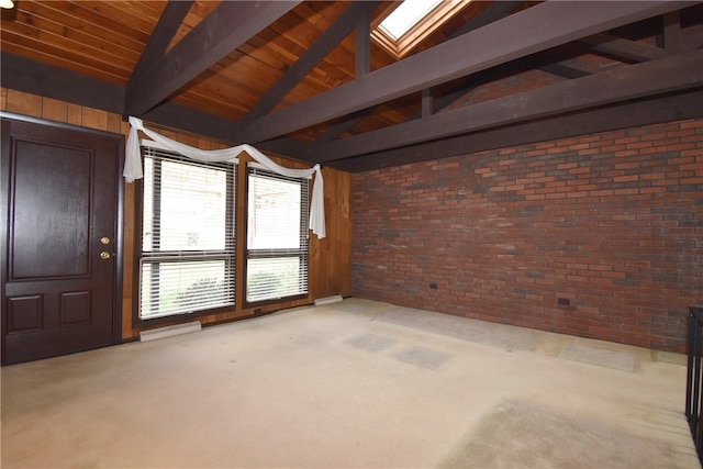 interior space featuring wood ceiling, light colored carpet, lofted ceiling with skylight, and brick wall