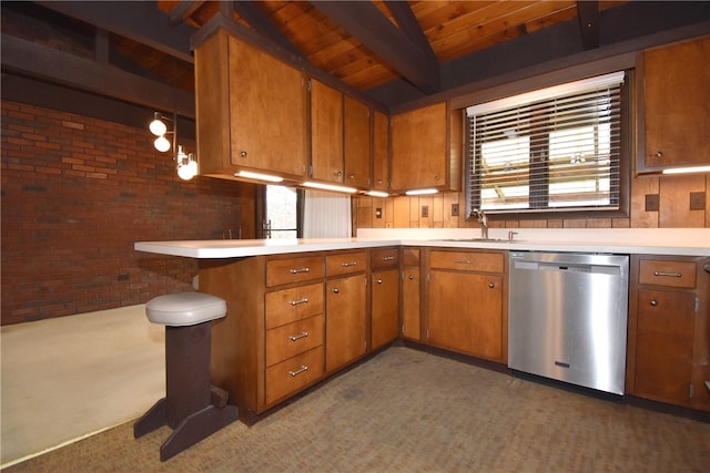 kitchen with dishwasher, beamed ceiling, brick wall, kitchen peninsula, and dark carpet