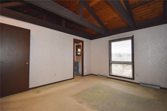 carpeted spare room featuring wooden ceiling and lofted ceiling with beams