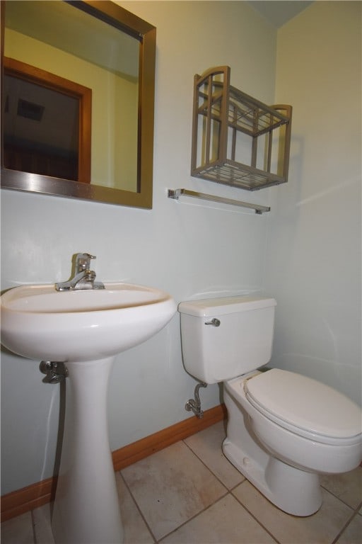 bathroom with tile patterned flooring, toilet, and sink