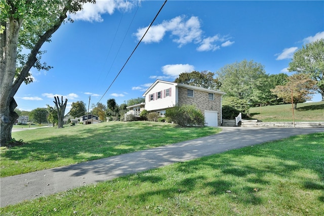 view of home's exterior featuring a yard and a garage