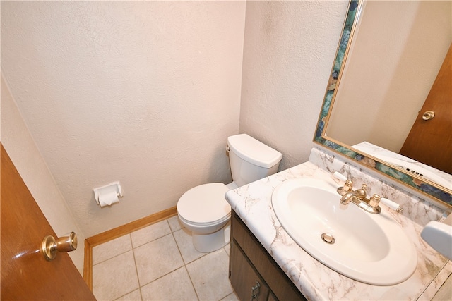 bathroom featuring tile patterned floors, vanity, and toilet