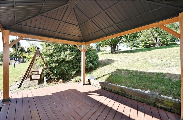 wooden terrace with a gazebo and a yard