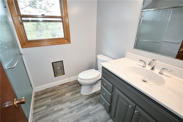 bathroom featuring toilet, vanity, and hardwood / wood-style flooring