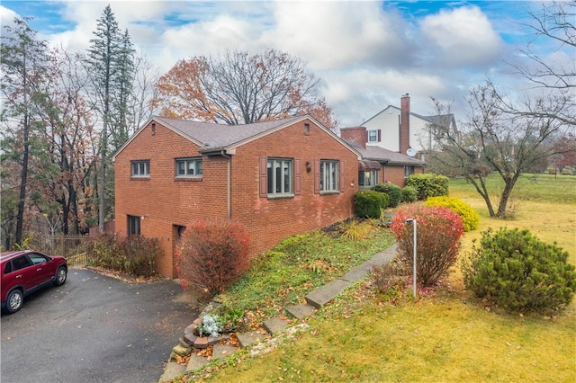 view of side of home with a yard