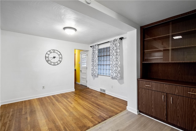 spare room with light hardwood / wood-style flooring