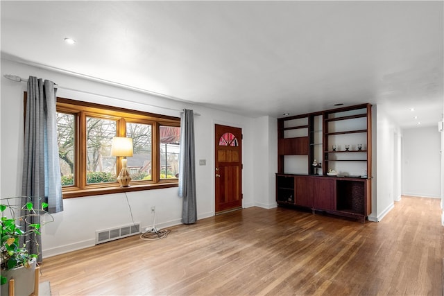 unfurnished living room with hardwood / wood-style flooring