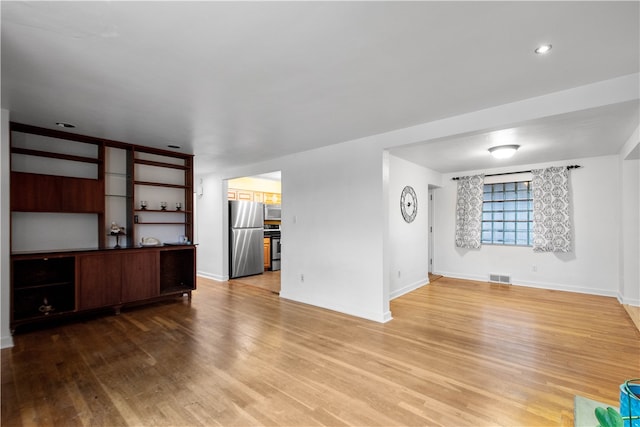 unfurnished living room with wood-type flooring