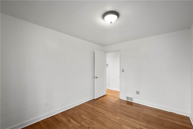 unfurnished room featuring hardwood / wood-style floors