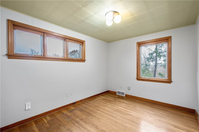 unfurnished room with light wood-type flooring