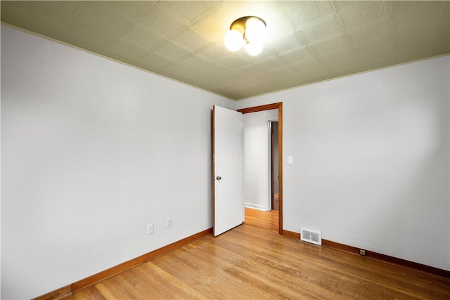 spare room featuring light wood-type flooring