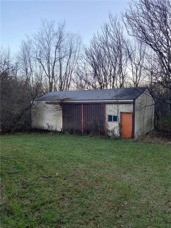 view of outdoor structure featuring a lawn