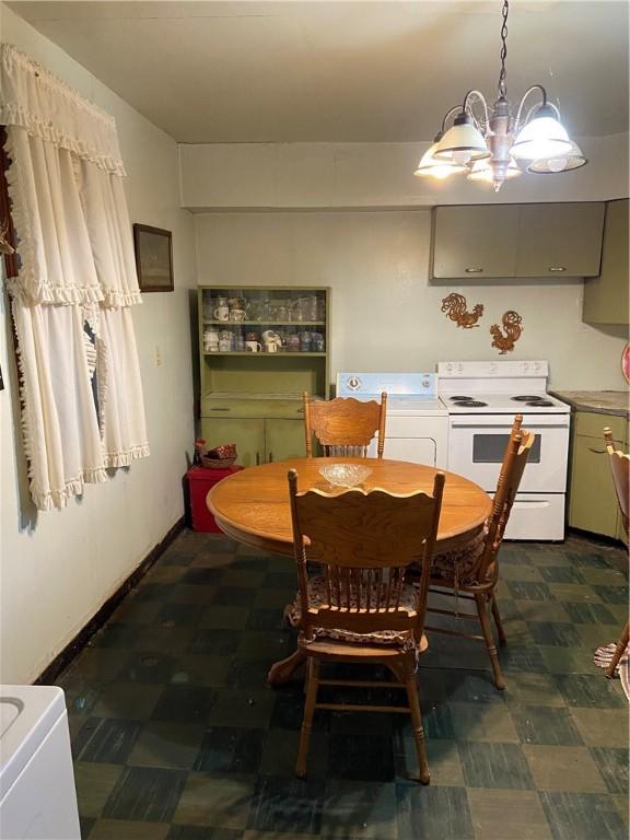 215 Cehily Rd, Allegheny Twp, PA 15068 - dining area featuring dark floors, washer / dryer, and a chandelier