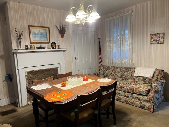 dining space featuring carpet and a notable chandelier