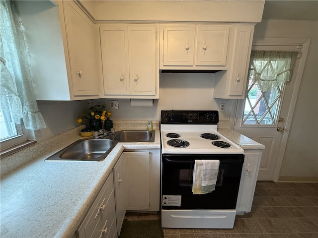 kitchen with white range with electric cooktop, white cabinetry, and sink