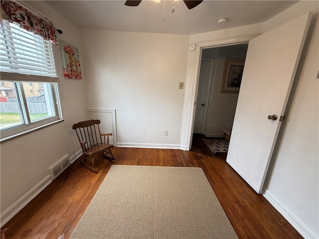 interior space with dark hardwood / wood-style floors and ceiling fan