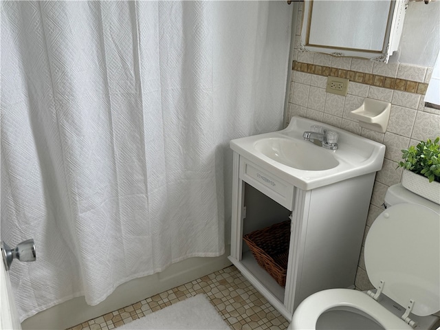 full bathroom with vanity, shower / bath combination with curtain, tile patterned flooring, toilet, and tile walls