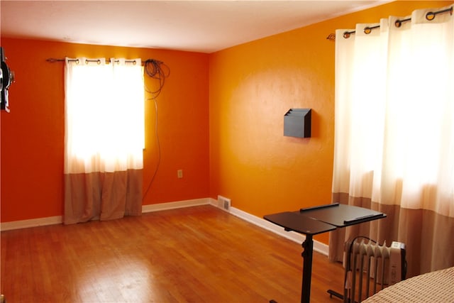 workout room with wood-type flooring