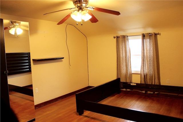 bedroom with ceiling fan and hardwood / wood-style floors