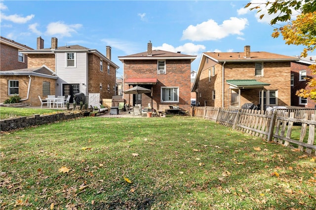 back of property with a patio area and a yard