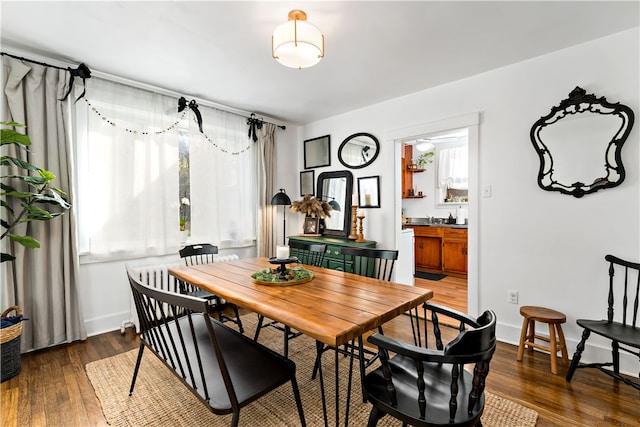 dining space featuring dark hardwood / wood-style floors