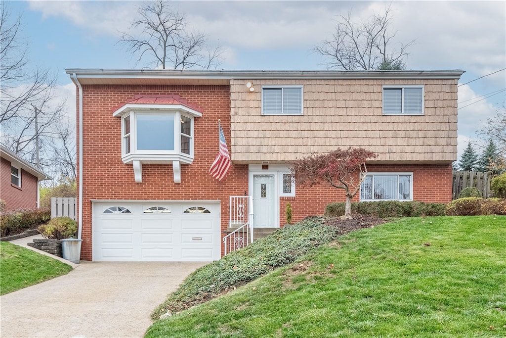 view of front facade with a garage and a front lawn