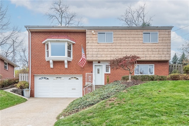 view of front facade with a garage and a front lawn