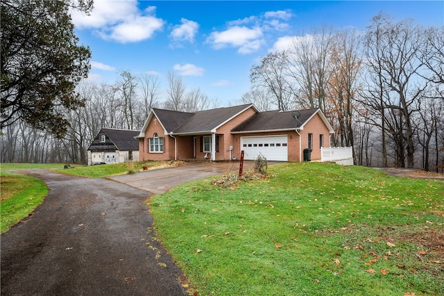 single story home with a front lawn and a garage