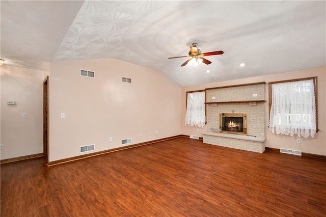 unfurnished living room featuring hardwood / wood-style floors, a brick fireplace, ceiling fan, and lofted ceiling