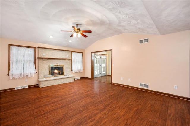 unfurnished living room with a fireplace, hardwood / wood-style flooring, ceiling fan, and lofted ceiling