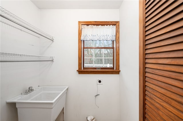 laundry area with sink and hookup for an electric dryer