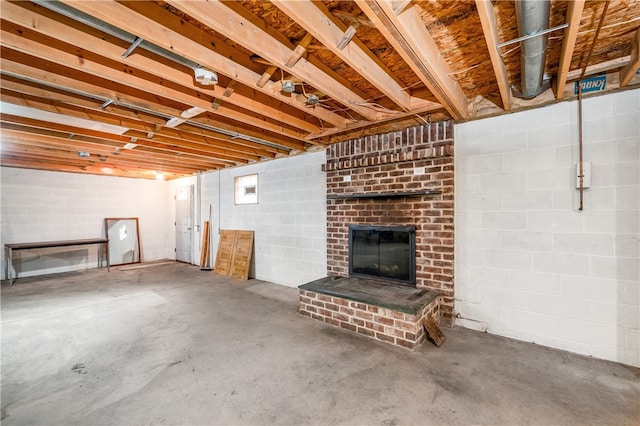 basement featuring a brick fireplace