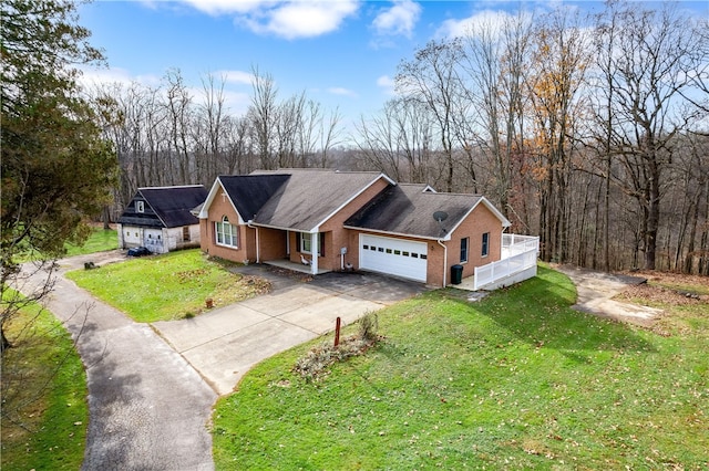 view of front of property with a garage and a front lawn