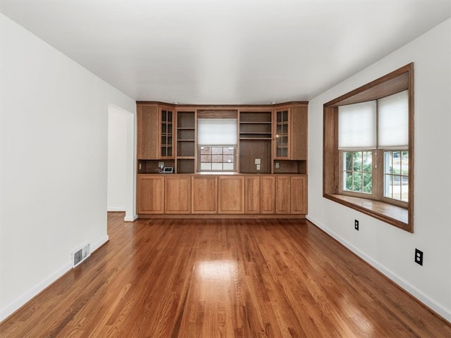 unfurnished living room featuring dark hardwood / wood-style flooring