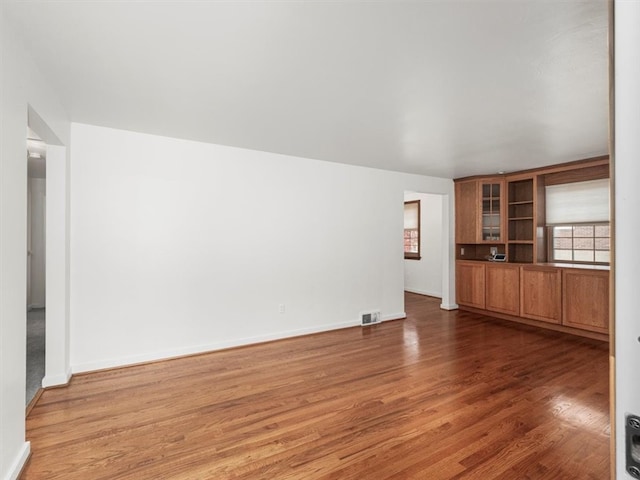 unfurnished living room featuring dark hardwood / wood-style flooring