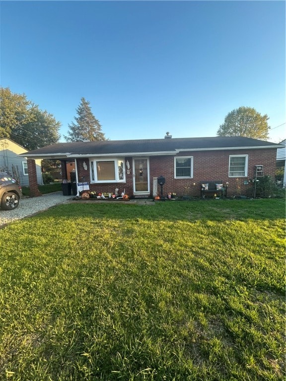 single story home with a carport and a front lawn