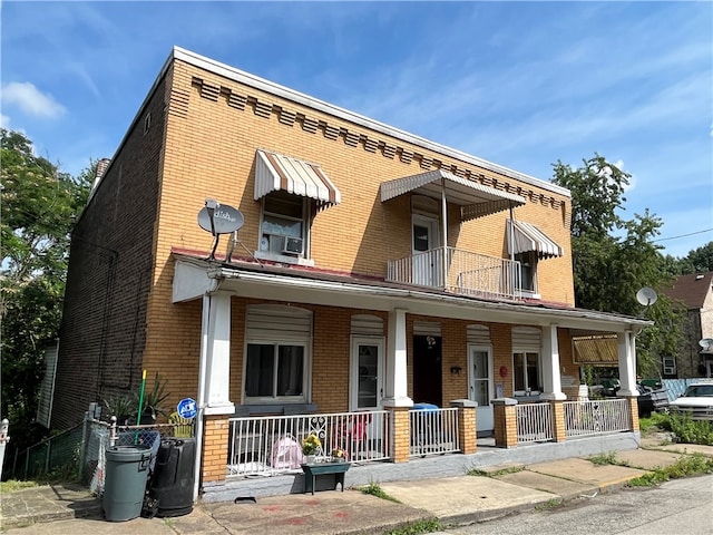 view of front of house featuring a balcony and covered porch