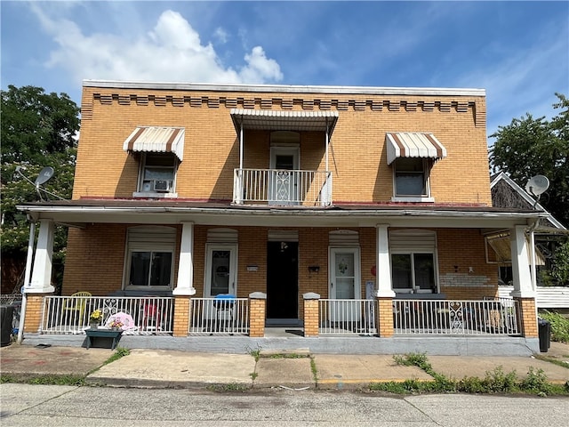 view of front of home with a balcony and covered porch