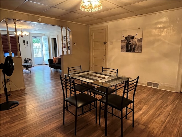 dining room featuring hardwood / wood-style floors and an inviting chandelier