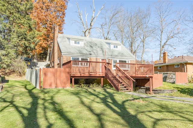 rear view of property featuring a yard and a deck