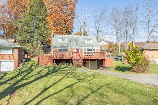 rear view of property with a lawn and a wooden deck