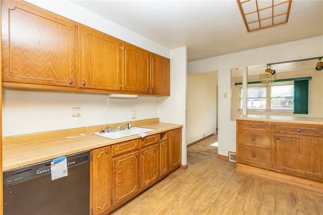 kitchen with dishwasher, sink, and light hardwood / wood-style floors