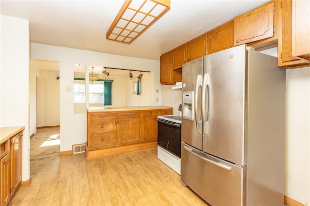 kitchen featuring white electric range oven, stainless steel refrigerator with ice dispenser, light wood-type flooring, and ventilation hood