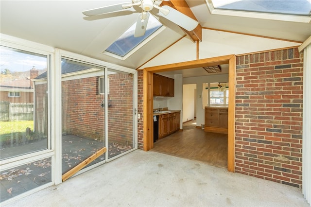 unfurnished sunroom with vaulted ceiling with beams and sink