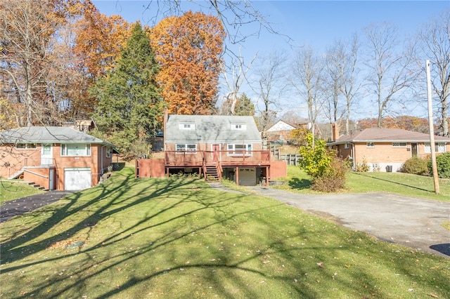 view of front of home featuring a front lawn, a deck, and a garage