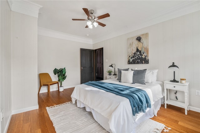 bedroom featuring hardwood / wood-style flooring, ceiling fan, and ornamental molding