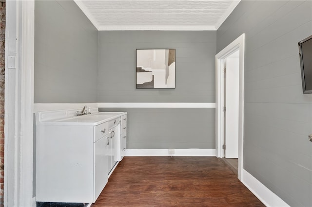 clothes washing area featuring dark hardwood / wood-style floors and sink