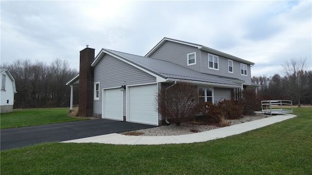 view of side of home with a yard and a garage