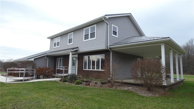 back of house featuring a lawn